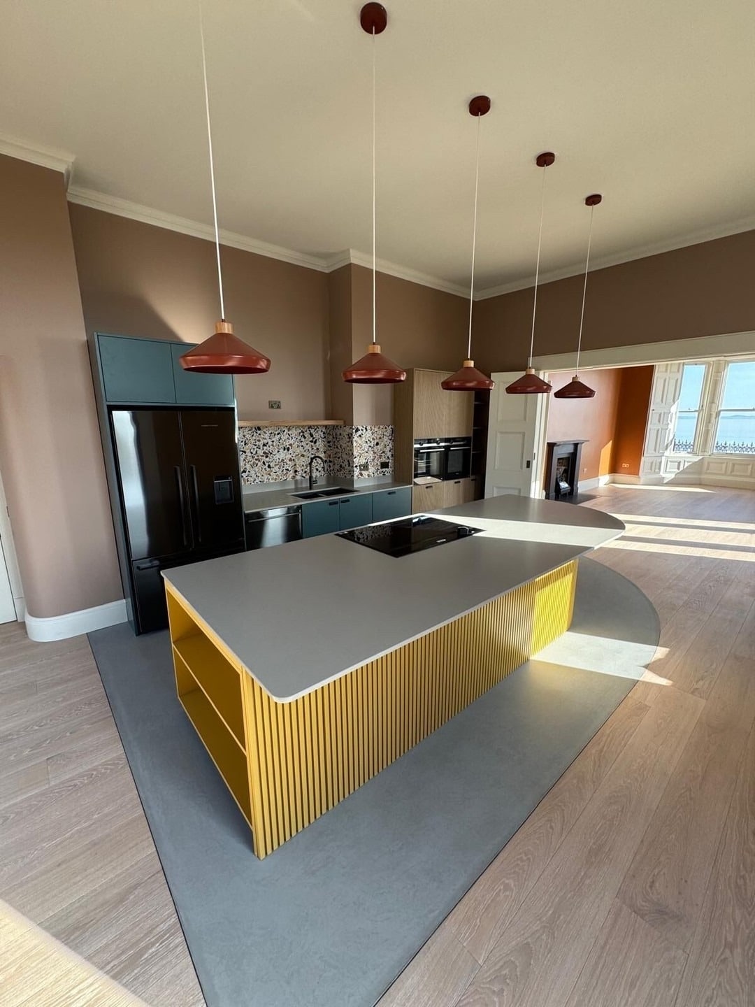 13. Modern Island Kitchen with Yellow Slatted Base and Charcoal Grey Appliances - yellow and grey kitchen ideas