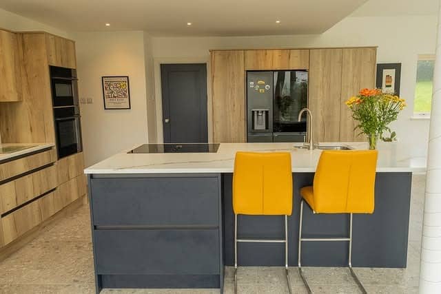 18. Charcoal Island Kitchen with Yellow Seating Accents - yellow and grey kitchen ideas