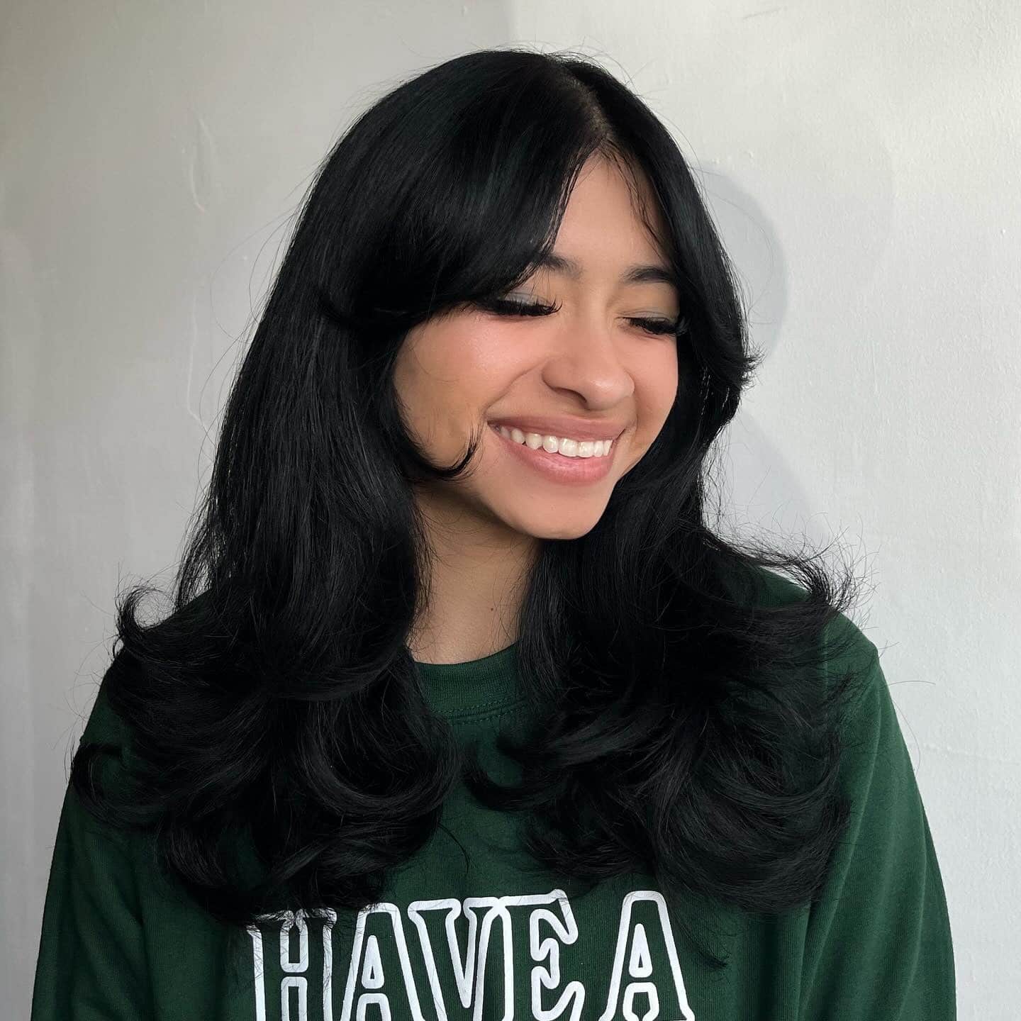 5. Jet-Black Layered Cut with Curtain Accents - Face-Framing Haircuts