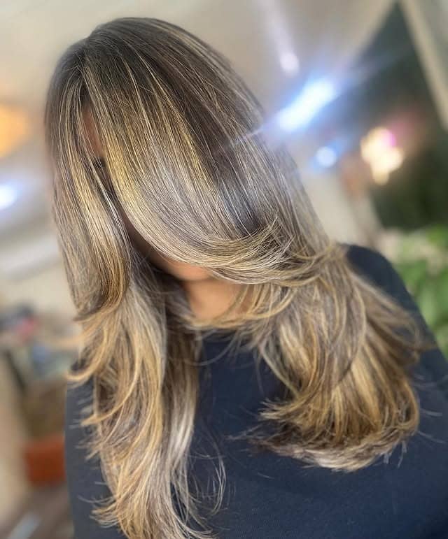 6. Golden Brunette Layered Cut with Voluminous Front Sweep - Face-Framing Haircuts