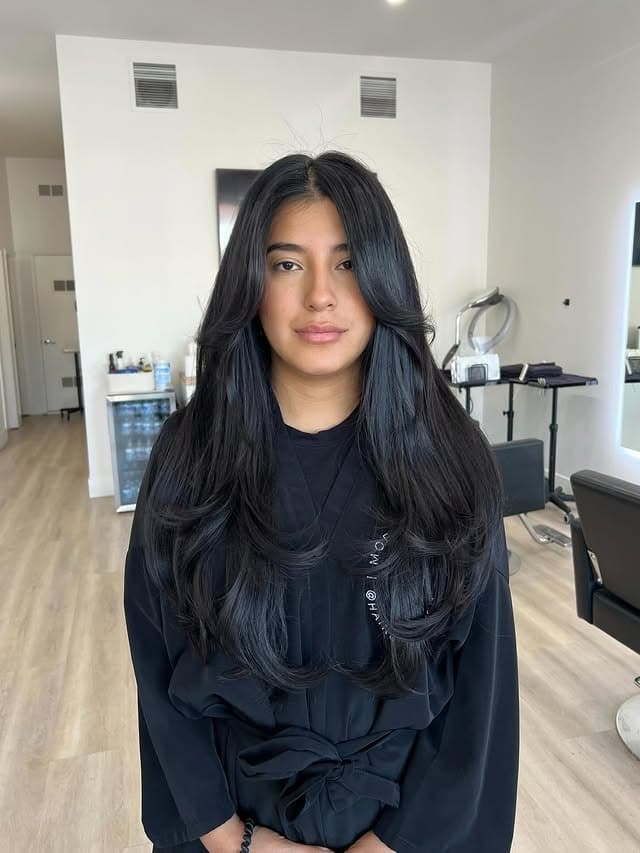 10. Long Jet-Black Layers with Soft Curtain Shaping - Face-Framing Haircuts