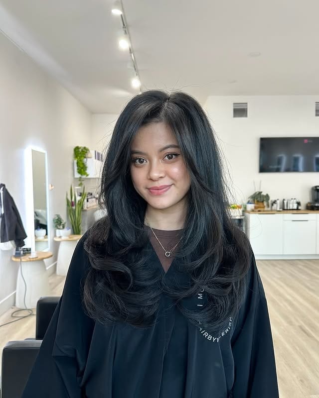 14. Deep Charcoal Layers with Voluminous Curved Framing - Face-Framing Haircuts