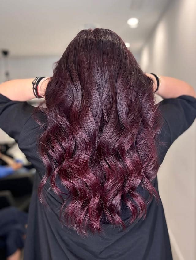 20. Glossy Merlot Waves With Sculpted Volume - Burgundy Balayage Hair Color