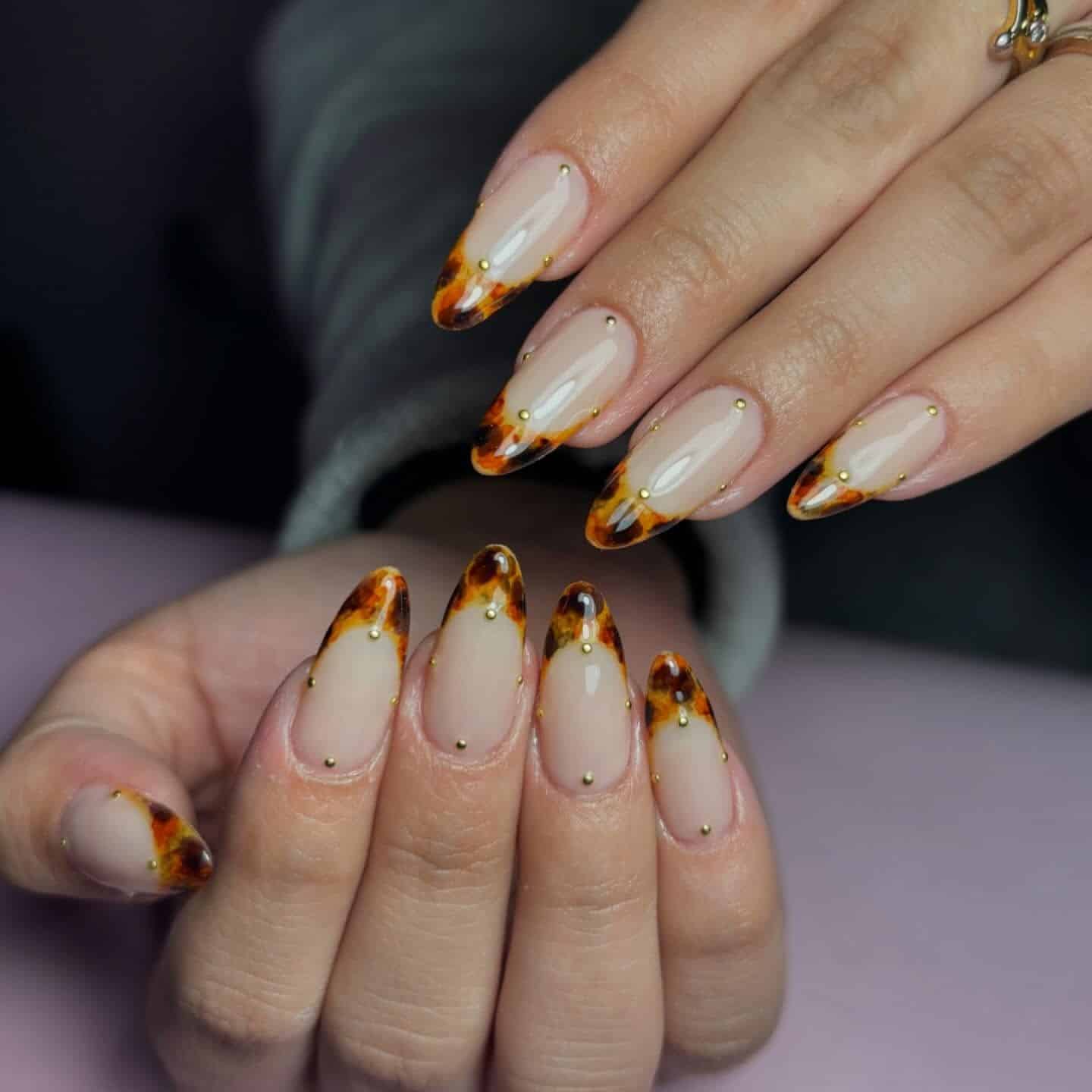 15. Tortoiseshell Almond French with Gold Studs - fall french nail ideas