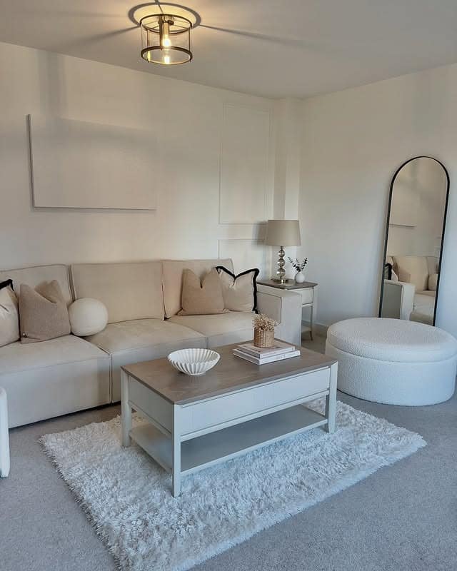 11. Arched Minimal Mirror Styling in Soft Ivory and Sand - mirrors in living room ideas