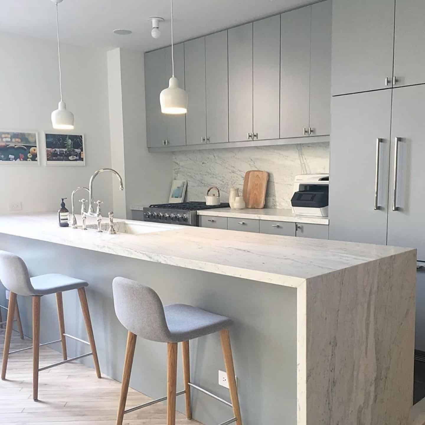 1. Marble-Wrapped Island with Soft Gray Cabinetry - light gray kitchen ideas