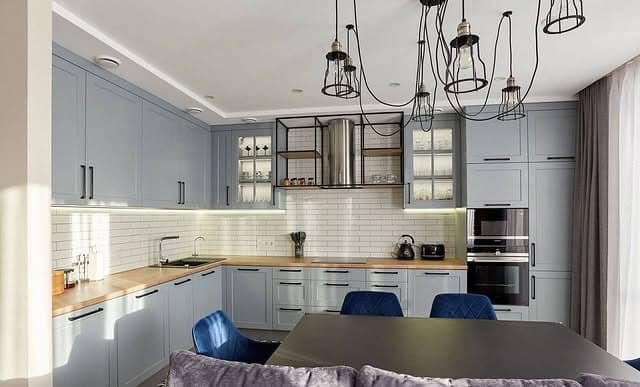 10. Smoky Gray Cabinets with Warm Wood Counters - light gray kitchen ideas