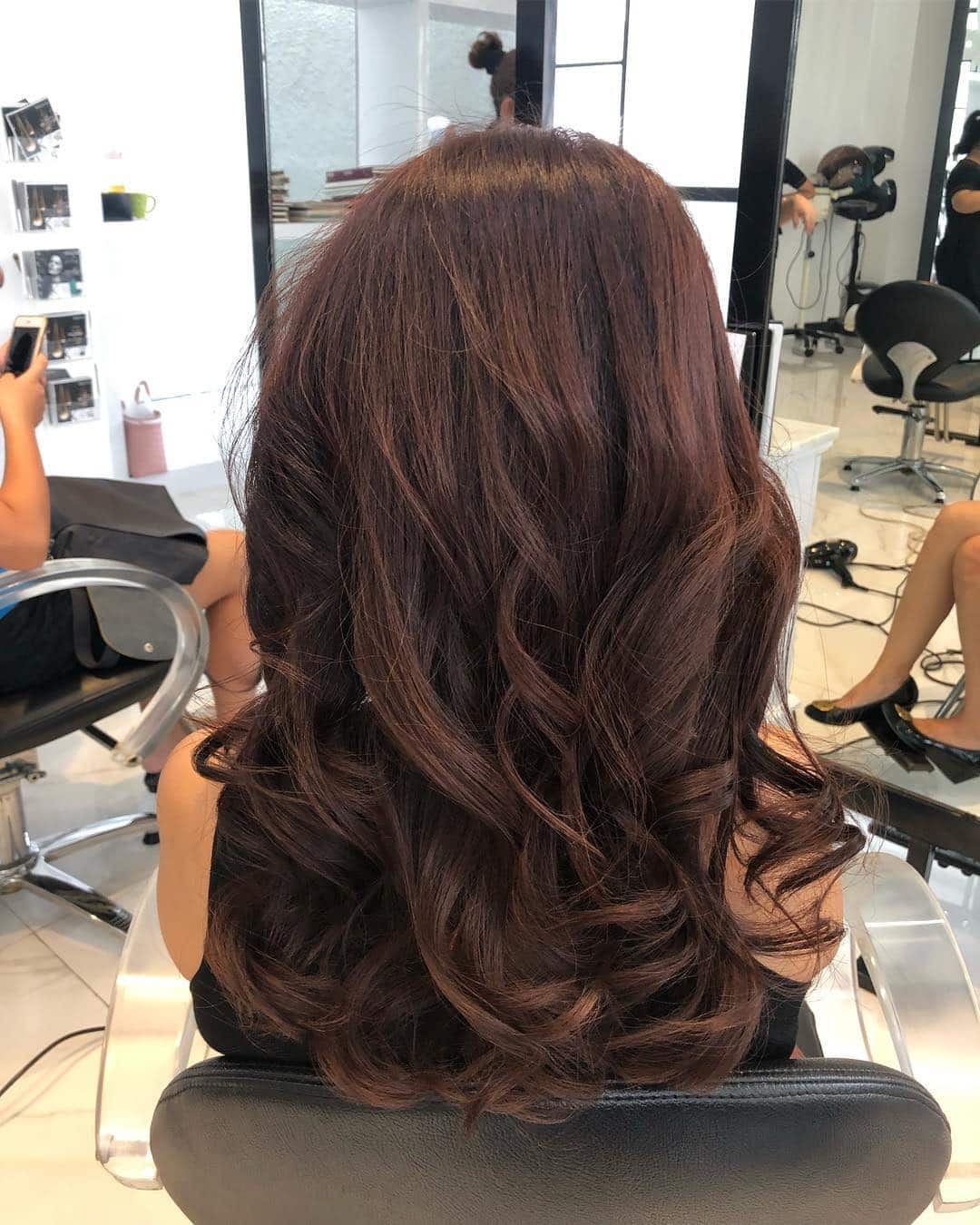 13. Voluminous Mahogany Curls with Layered Bounce - Mahogany Hair Color