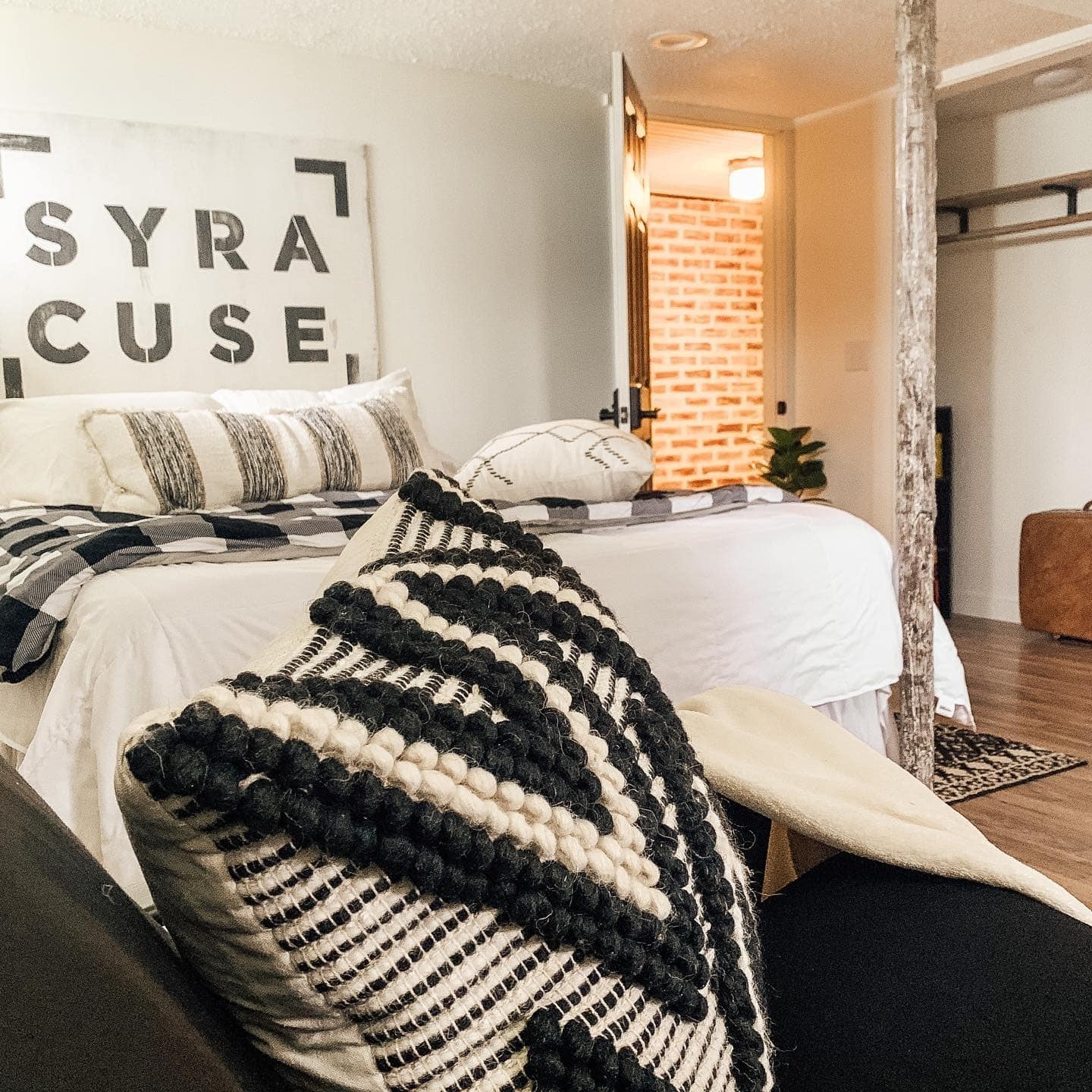 11. Black-and-Cream Textures with Urban Art Accent - basement bedroom ideas