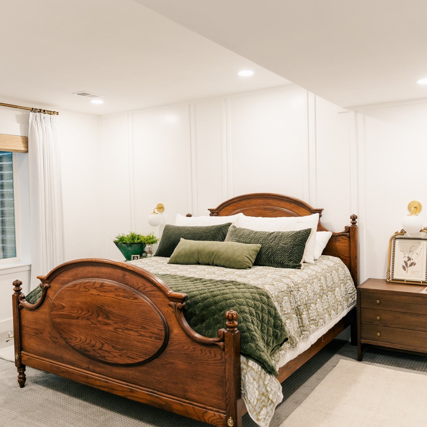 16. Classic Wood Bedframe with Layered Greens - basement bedroom ideas