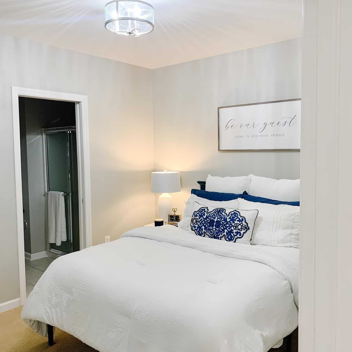 17. Crisp White Bedding with Blue Statement Accents - basement bedroom ideas