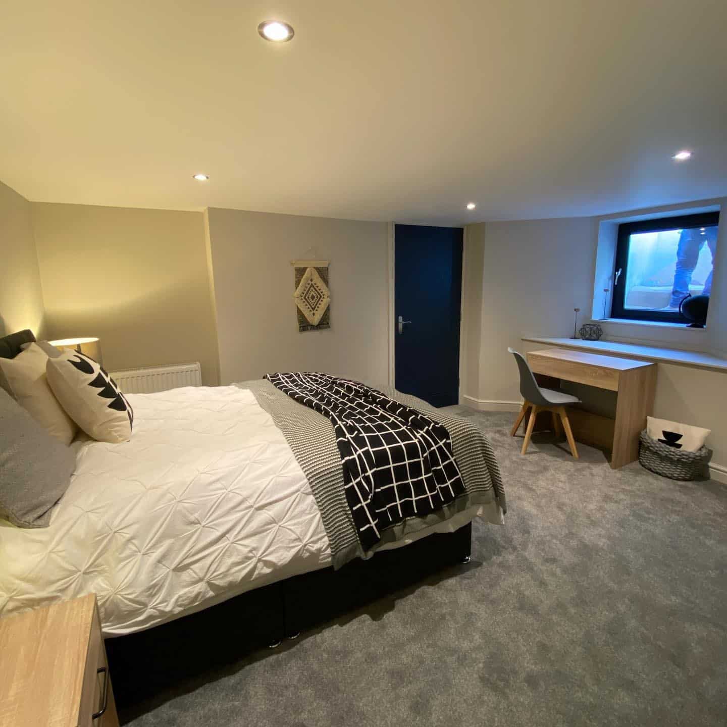 20. Monochrome Black-and-White with Functional Workspace - basement bedroom ideas