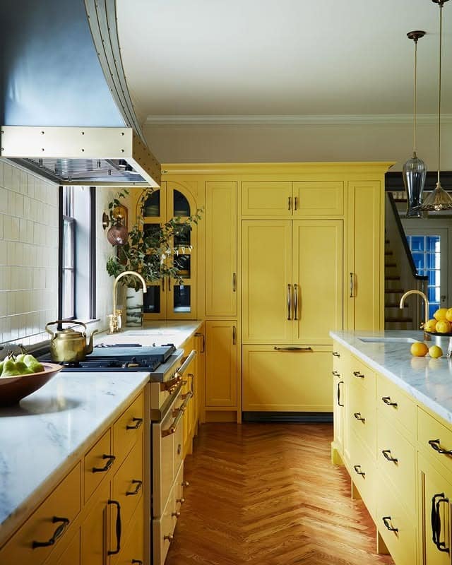 2. Elegant Golden Cabinetry With Brass Details and Marble Countertops - yellow kitchen ideas