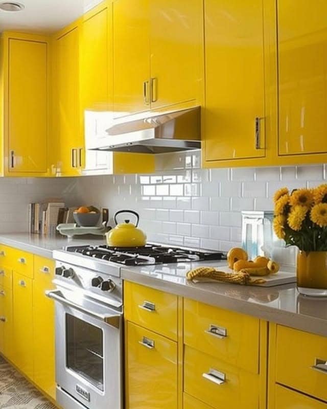 17. High-Gloss Sunshine Cabinets With Chrome Details - yellow kitchen ideas