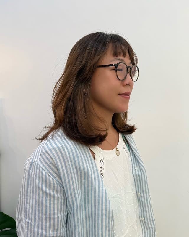 12. Warm Brown Lob With Soft Feathered Ends and Fringe - Lob Hairstyles