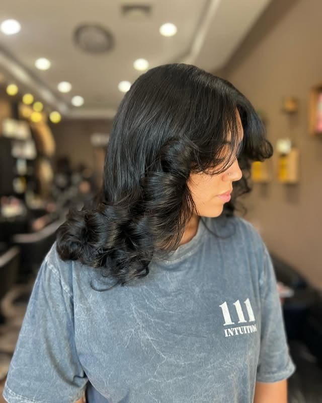 12. Glossy Black Layers with Sculpted Curls - Short Layered Haircuts