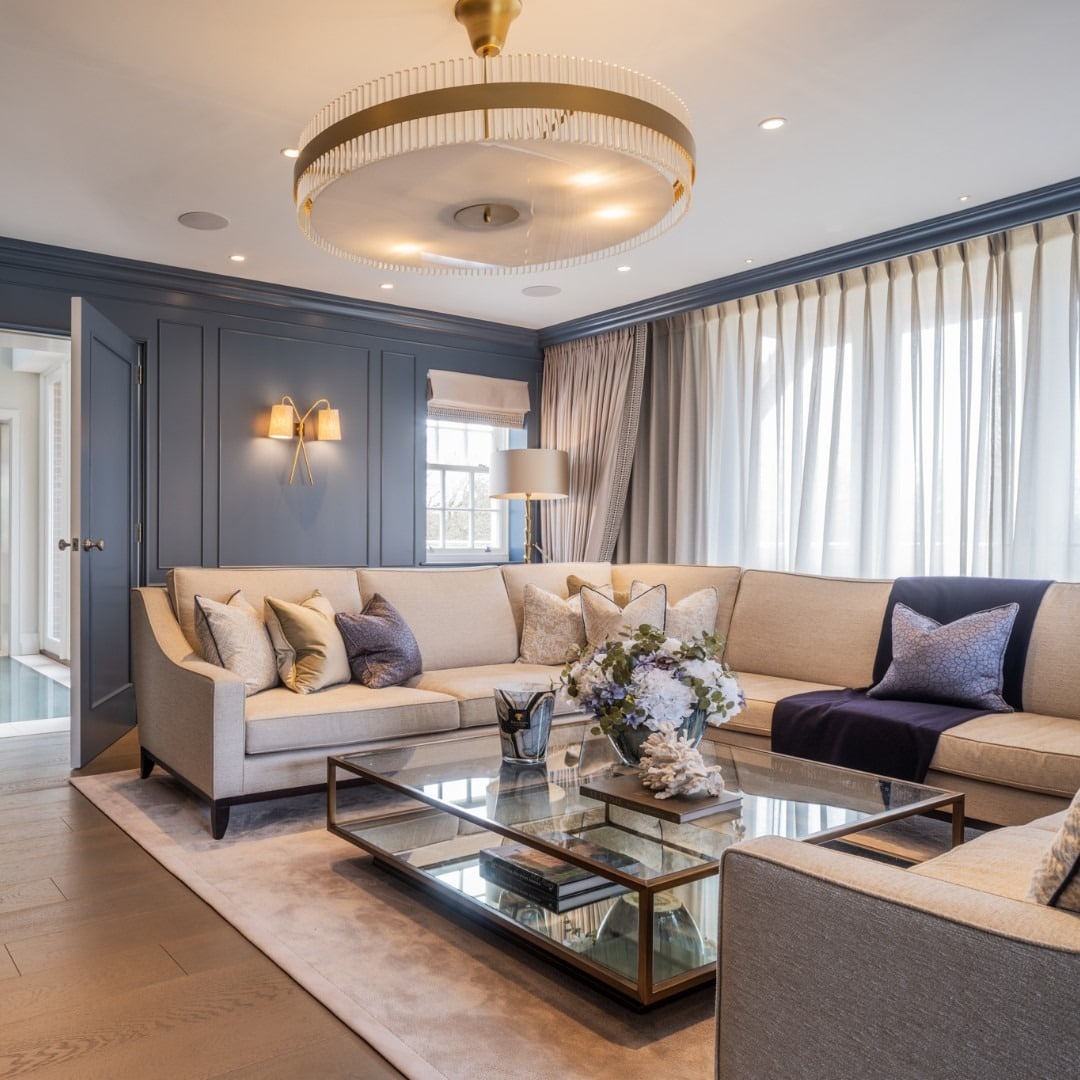 8. Sophisticated Blue Paneling with Soft Cream Seating - home decor ideas for living room