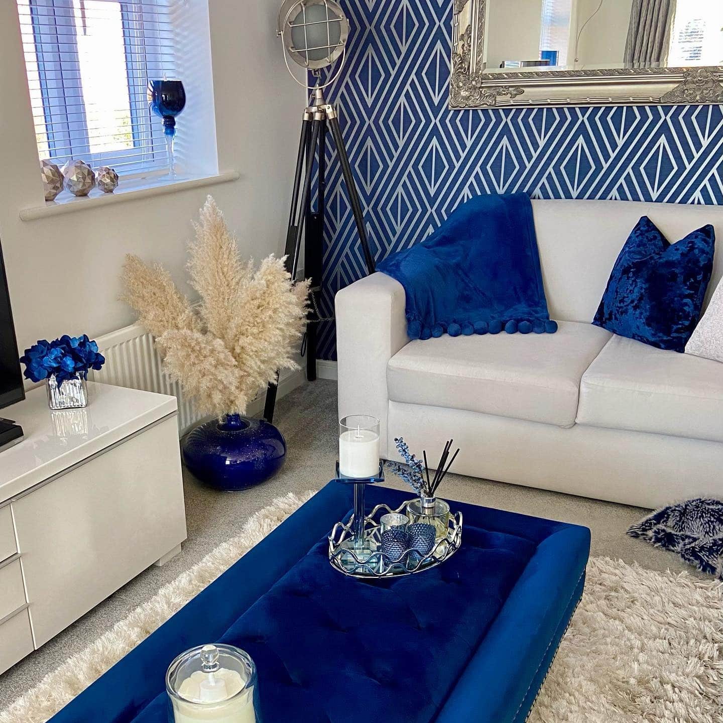 7. Chic Blue-and-White Lounge with Patterned Wallpaper - royal blue living room ideas