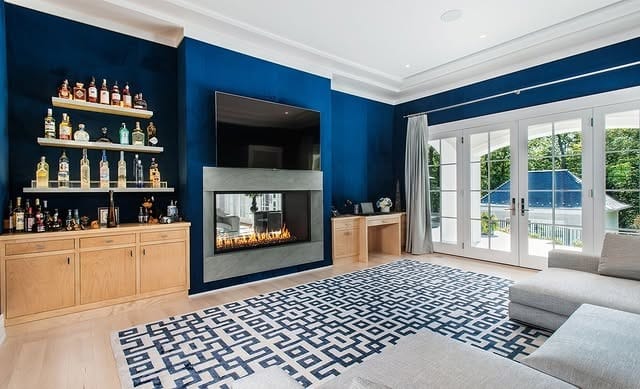 8. Royal Blue Fireplace Room with Modern Cabinetry - royal blue living room ideas