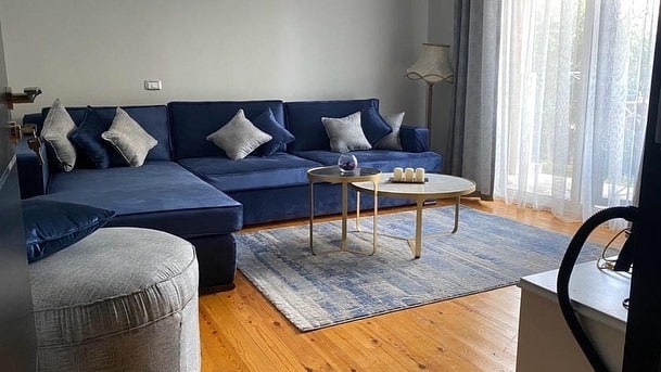 15. Minimalist Royal Blue Sectional with Soft Grey Accents - royal blue living room ideas
