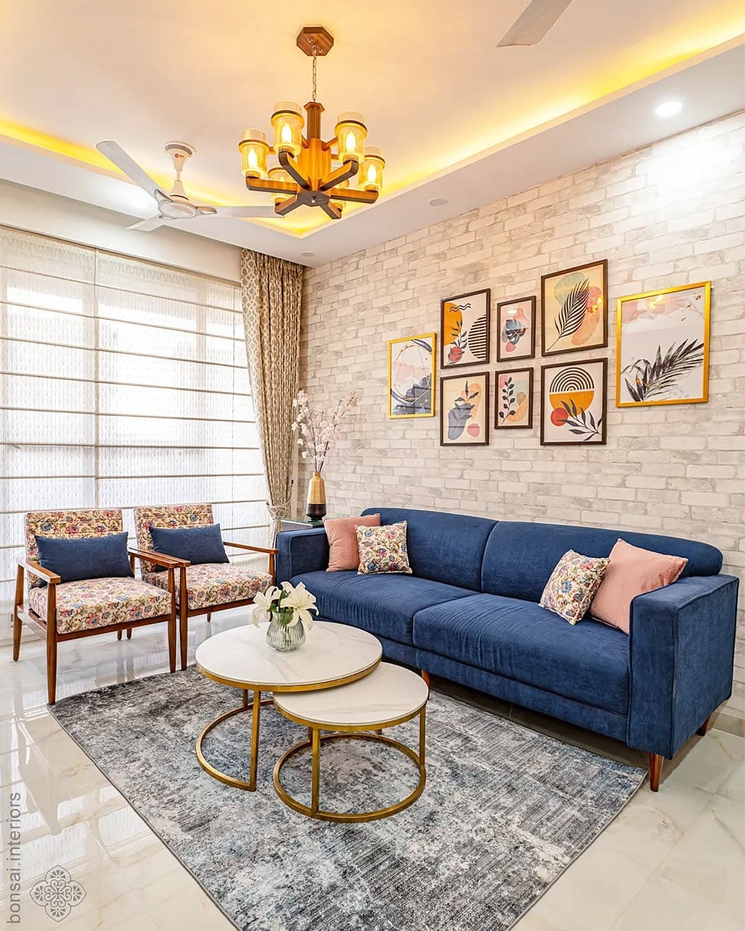 16. Brick Feature Wall with Royal Blue Seating and Gold Lighting - royal blue living room ideas