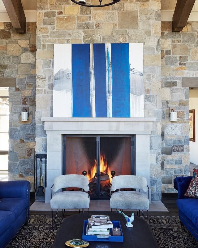 19. Stone Fireplace Living Room with Royal Blue Highlights - royal blue living room ideas