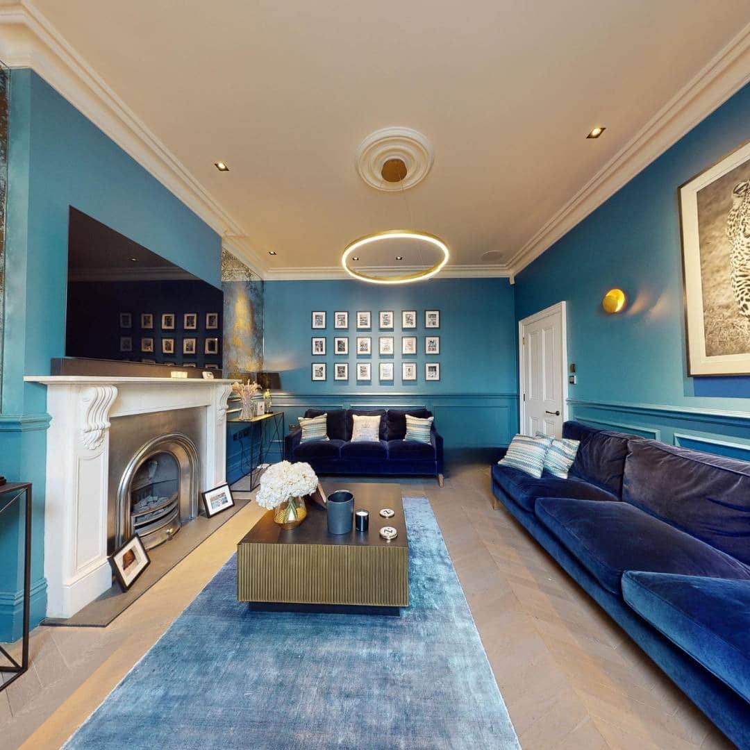 21. Layered Blues with Contemporary Fireplace Detailing - royal blue living room ideas