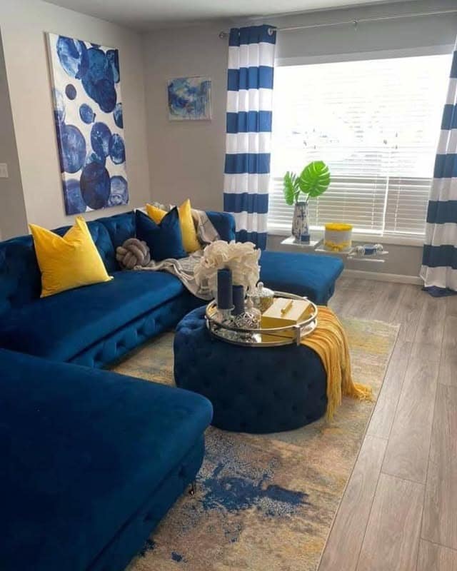 22. Royal Blue Sectional with Bold Stripe Accents - royal blue living room ideas