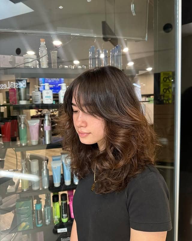 13. Rich Brunette Voluminous Shag with Curtain Bangs - Shaggy Haircut