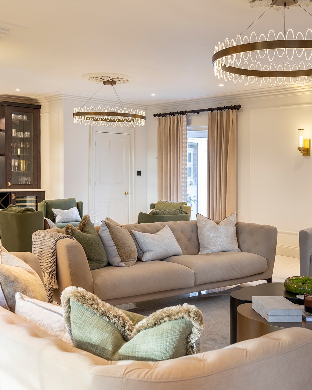 10. Elegant Neutral Living Room with Circular Statement Chandeliers - lighting ideas for living room