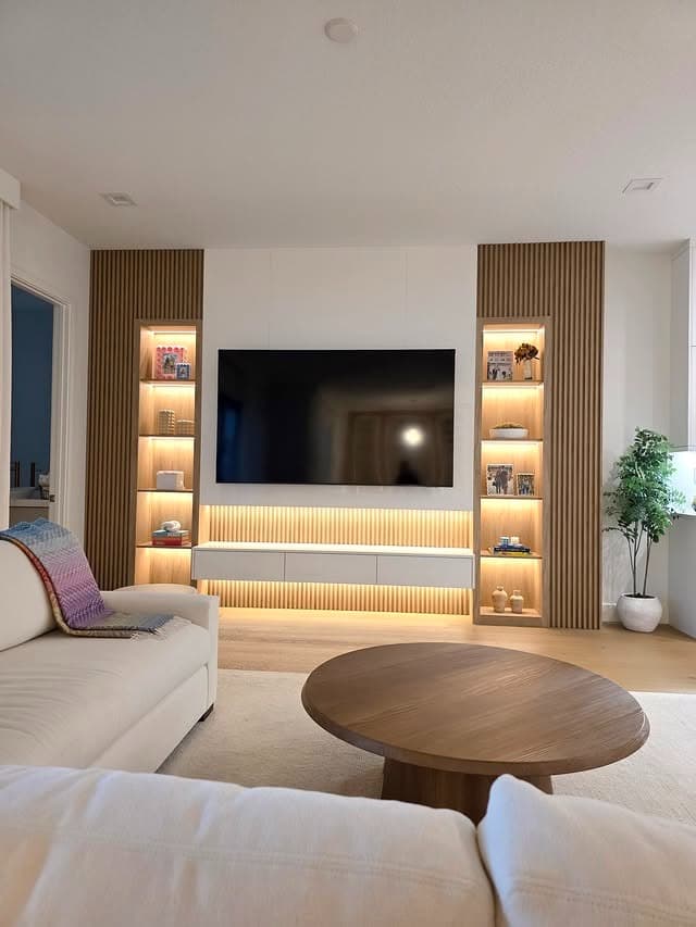 13. Illuminated Display Shelves with Warm Wood Tones - lighting ideas for living room