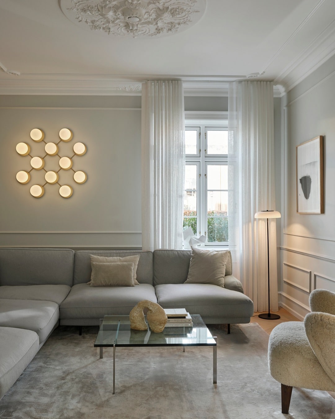 15. Circular Wall Lighting in a Soft Gray Living Room - lighting ideas for living room