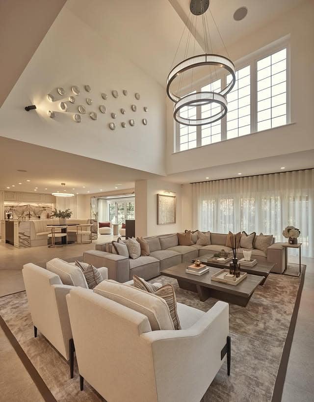 16. Grand Double-Height Lighting in Cream and Taupe - lighting ideas for living room