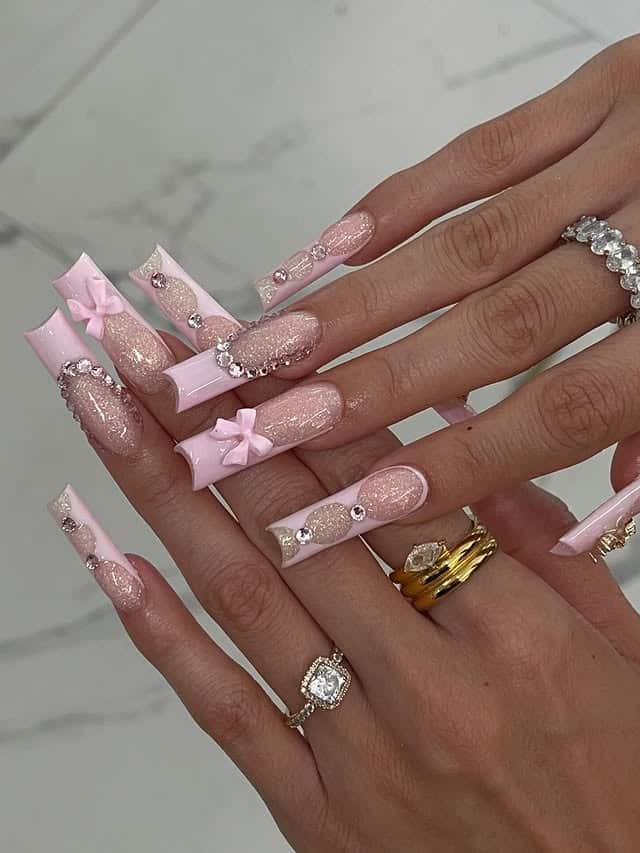 13. Sparkling Baby Pink Long Nails with Bow Charms - girly nail ideas