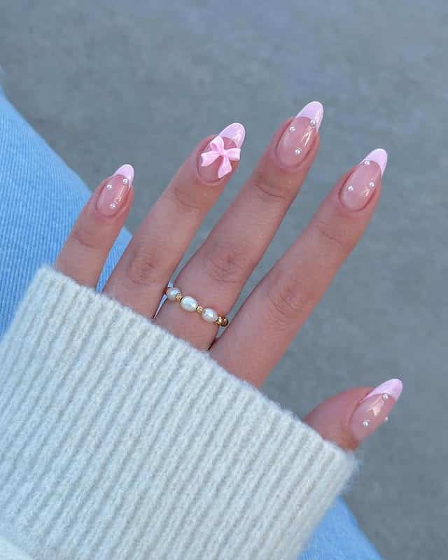 21. Soft Pink Almond French Tips with Bow Accent - girly nail ideas