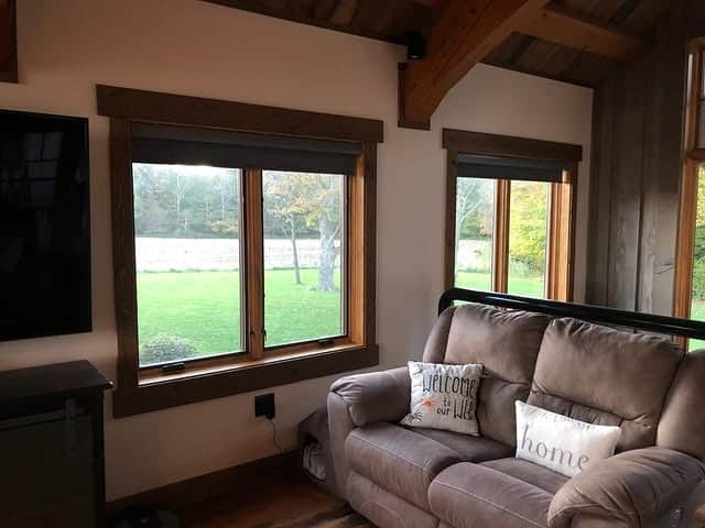 5. Warm Taupe Seating Framed by Natural Light - dark brown living room ideas