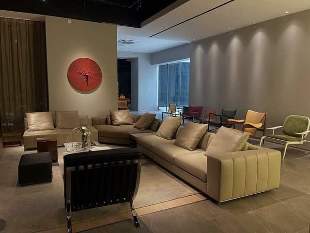 14. Taupe and Espresso Seating in a Minimalist Layout - dark brown living room ideas