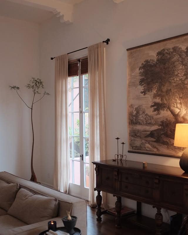 17. Vintage Console and Art in a Warm White Setting - dark brown living room ideas