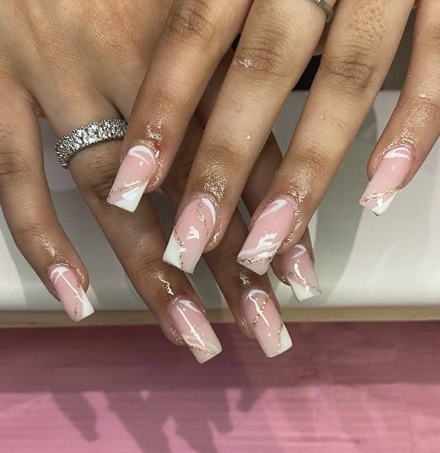 3. Soft French Swirls with Gold Accents - gold and white nail ideas