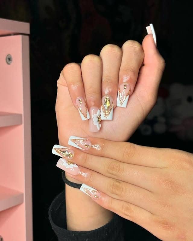 4. Gold-Trimmed Luxe French with Embellishments - gold and white nail ideas