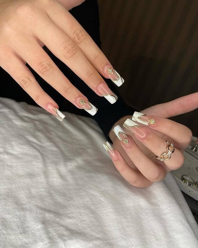 8. Bold White Panels with Gold Sunburst Charms - gold and white nail ideas