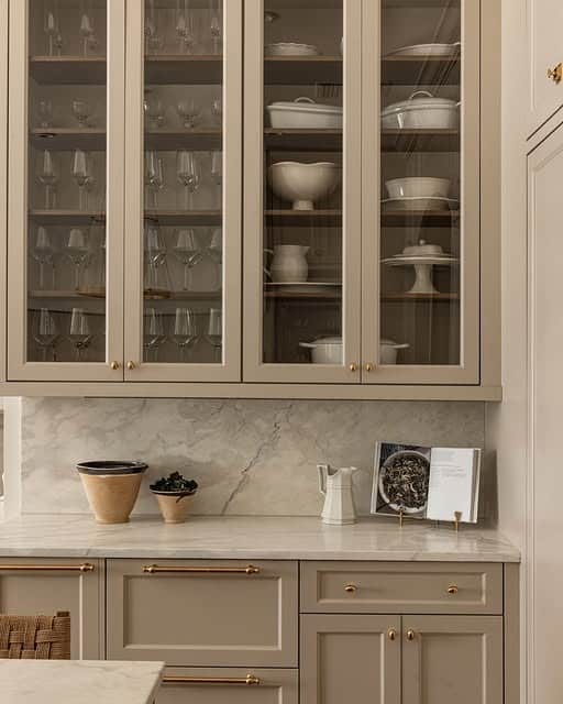 5. Warm Taupe Glass Cabinets with Classic Elegance - kitchen ideas with shelves