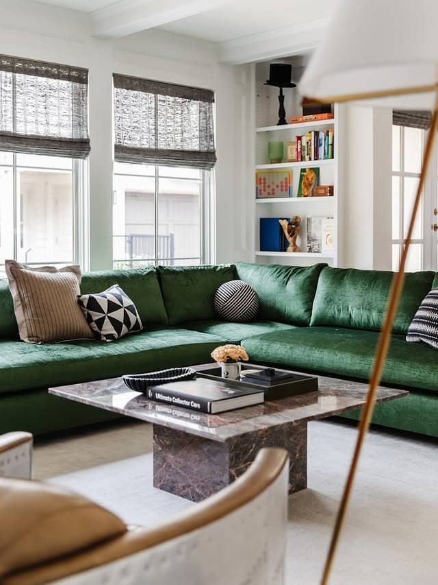 1. Modern Emerald Lounge with Sculptural Accents - green couch living room ideas