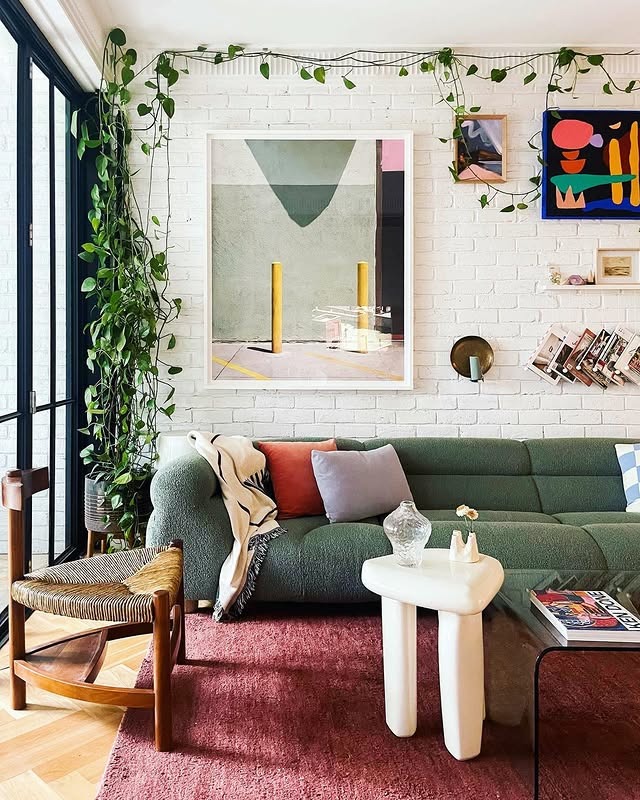 3. Playful Green Sofa in an Eclectic Brick Loft - green couch living room ideas