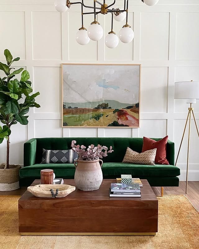 4. Emerald Statement Sofa in a Light-Filled Sitting Room - green couch living room ideas