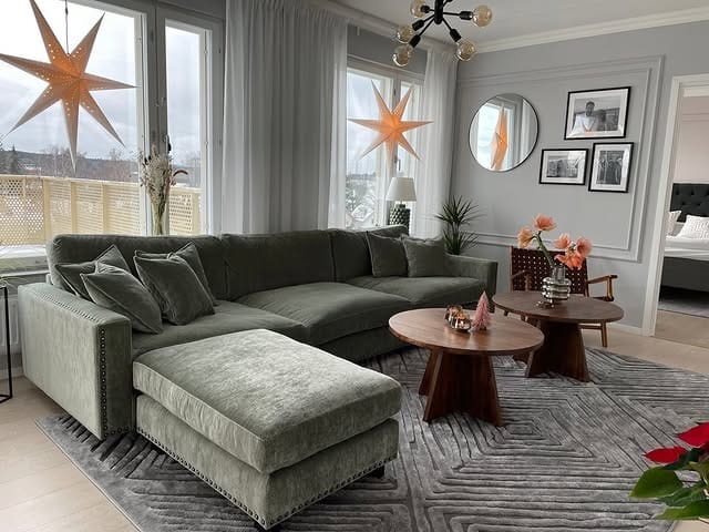 10. Soft Sage Sectional in a Scandinavian-Inspired Living Room - green couch living room ideas