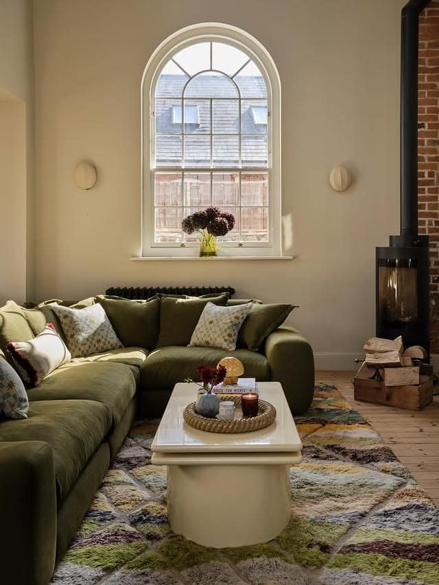 14. Warm Olive Sectional with Cozy Layering - green couch living room ideas