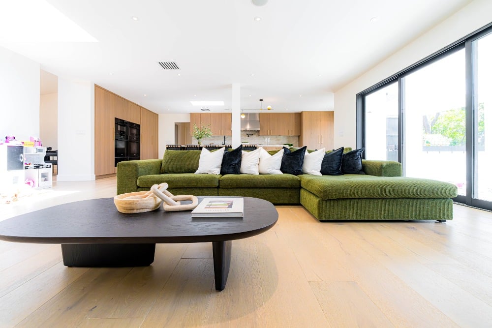 19. Modern Olive Sectional in a Minimal Open-Plan Home - green couch living room ideas