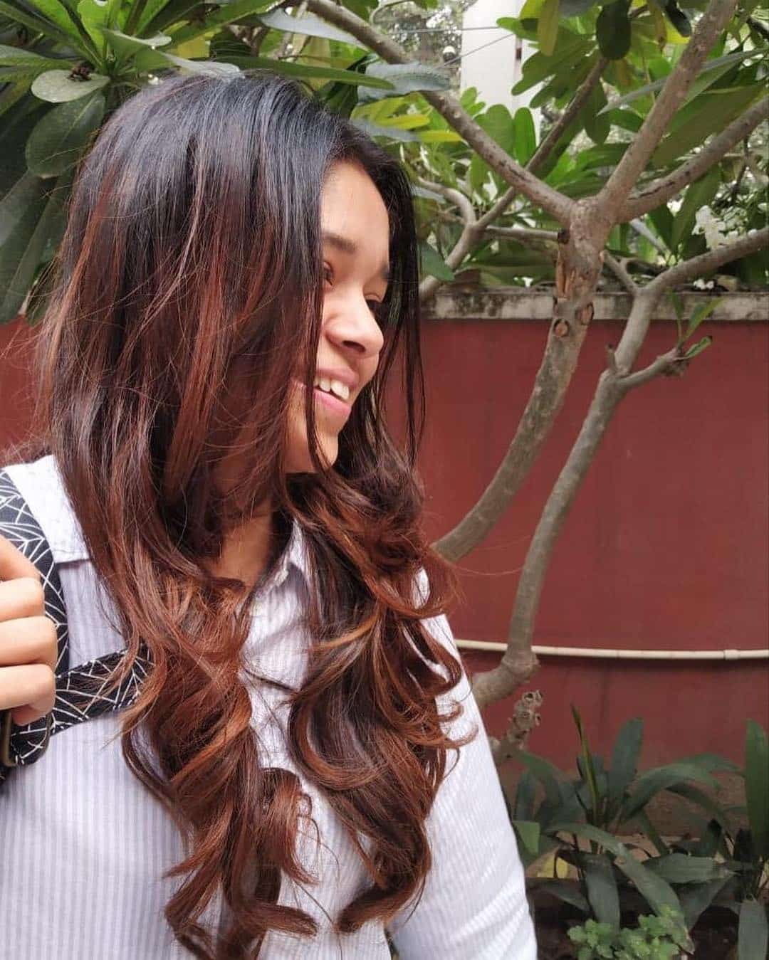 7. Cascading Auburn Curls with Natural Depth - Dark Auburn Hair Color