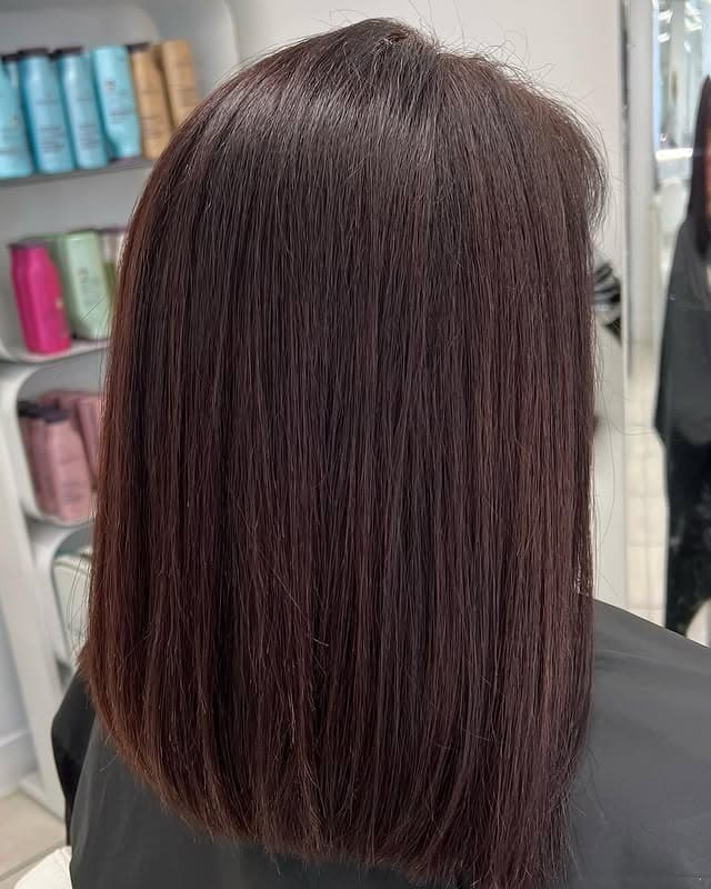 19. Polished Mid-Length Cut in Auburn - Dark Auburn Hair Color